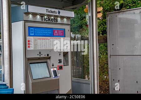Self service train ticket machine at Brundall Gardens railway station in the Norfolk village of Brundall Stock Photo