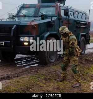 Ukraine modern soldier moves undercover armored car Stock Photo