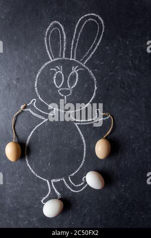 Easter bunny with eggs. Green grass and eggs. Chalk drawn bunny with real grass and eggs. Stock Photo