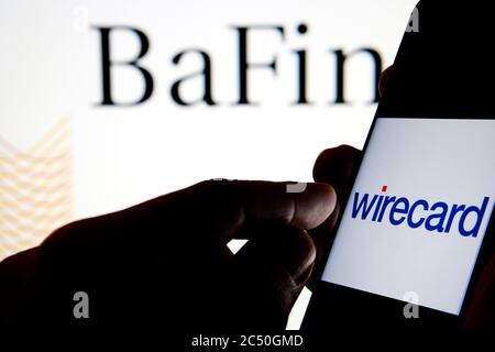 Wirecard logo on smartphone and BaFin (Federal Financial Supervisory Authority) logo on the blurred background screen. Stock Photo