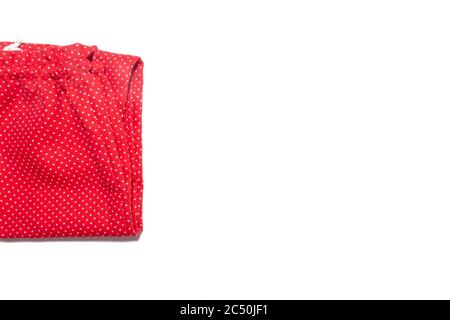 Kid's red with white polka dot pattern pants folded isolated on white Stock Photo