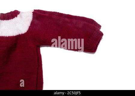 A warm knitted dark red or wine coloured sweater with white stripe. Kid's clothes and apparel isolated on white. Winter and christamas clothes. Stock Photo