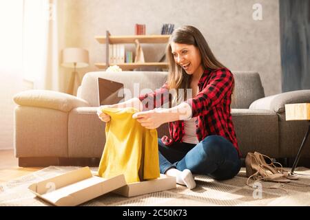 Happy girl has received a package of an online ordered Stock Photo