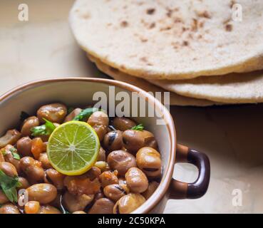 Ful Medames - Dish of Egyptian fava beans with lemon ,cumin ,vegetable Stock Photo