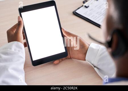 African doctor holding using digital tabelt mock up white screen, close up. Stock Photo