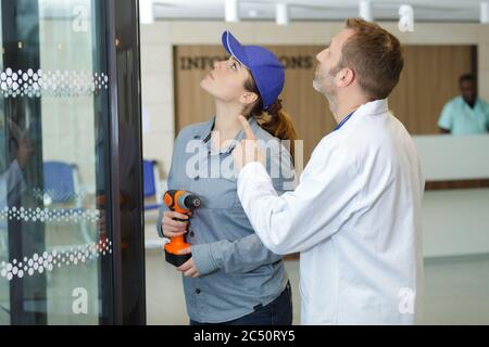 young female technician fixing an issue in hospital Stock Photo