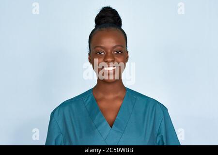 Happy young female african scrub nurse wear blue uniform isolated on background. Stock Photo