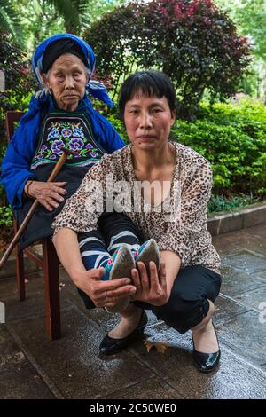 Kunming, China - June 24, 2019: Portrait of a Chinese woman that had her feet bound (footbinding) also called Lotus Feet Stock Photo