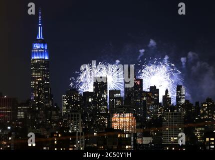 New York, USA. 29th June, 2020. Fireworks for the annual Macy's Fourth of July fireworks show light up behind The Empire State Building and the Manhattan skyline on Monday, June 29, 2020 in Union City, New Jersey. Macy's put on the first of what it says will be several small, unannounced fireworks displays ahead of the upcoming Fourth of July Holiday. New York City prepares to enter phase 3 of a four-part reopening plan on July 6 after being closed for almost 4 months due to COVID-19. Photo by John Angelillo/UPI Credit: UPI/Alamy Live News Stock Photo