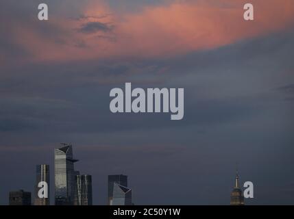 City, United States. 29th June, 2020. The sun sets on Hudson Yards, The Empire State Building and the Manhattan skyline after a thunderstorm on Monday, June 29, 2020 in Union City, New Jersey. New York City prepares to enter phase 3 of a four-part reopening plan on July 6 after being closed for almost 4 months due to COVID-19. Photo by John Angelillo/UPI Credit: UPI/Alamy Live News Stock Photo