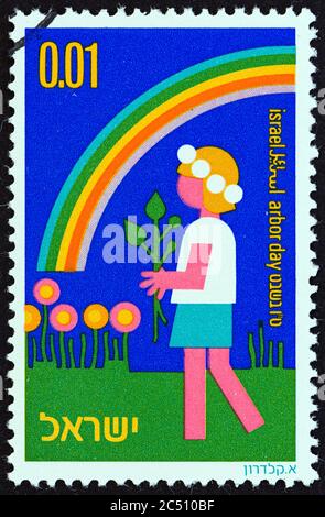 ISRAEL - CIRCA 1975: A stamp printed in Israel from the 'Arbor Day' issue shows Child with plant and rainbow, circa 1975. Stock Photo