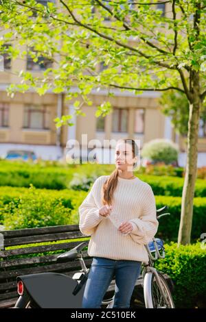 Young girl standing outdoors on sunny day Stock Photo