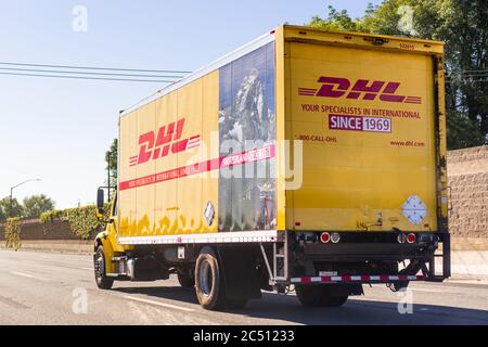 June 18, 2020 Redwood City / CA / USA - DHL truck driving on the freeway; DHL (Dalsey, Hillblom and Lynn) International GmbH is an American-founded Ge Stock Photo