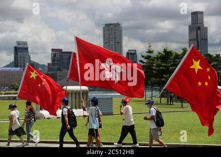 Hong Kong, China. 30th June, 2020. Pro-Beijing supporters wave Chinas national flags ahead to a rally in celebration of the passing a national security law on June 30, 2020 in Hong Kong, China. Beijing has passed the controversial national security law which will threaten the cities autonomy and political freedoms (Credit Image: © May JamesZUMA Wire) Stock Photo