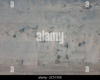 Poor condition of the road surface. Pits and potholes with cracks in the asphalt. Dangerous road. Stock Photo