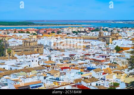 Aerial cityscape of Sanlucar town of Sherry Triangle with white houses, tile rofs, churches of Santo Domingo and San Francisco, Guadalquivir river, Sp Stock Photo