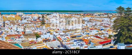 The panoramic view over the roofs of Sanlucar with historic city districts and Guadalquivir river on the distance, Spain Stock Photo