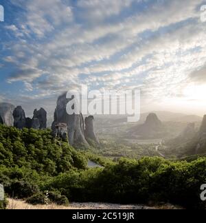 misty at sunset of hot day on Moni Agias Varvaras Roussanou on top of rock Meteora, Greece Stock Photo