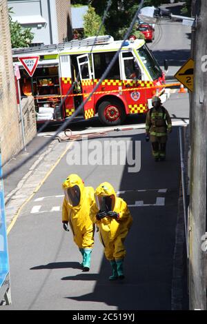 NSW Fire Brigades workers dressed in hazardous materials gear attend to the incident on St James Lane in Glebe. Stock Photo