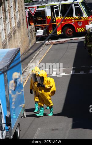 NSW Fire Brigades workers dressed in hazardous materials gear attend to the incident on St James Lane in Glebe. Stock Photo