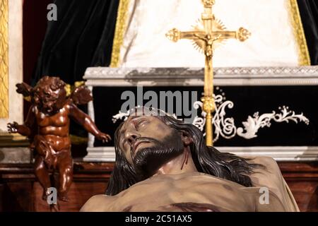 Jaen, Spain - June 18, 2020:  Detail of the face of Christ death sculpture in a chapel of Basilica of San Ildefonso in Jaen, Andalusia, Spain Stock Photo