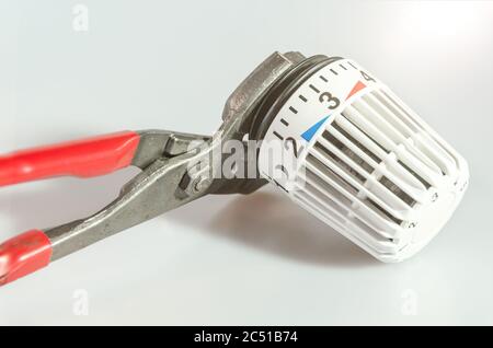 Closeup of heating controller and pipe wrench Stock Photo