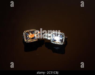 Jewelry, silver diamond earrings on a dark background. Stock Photo
