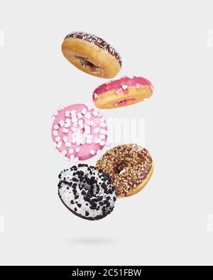 mix of multicolored sweet donuts with sprinkles isolated on white background Stock Photo