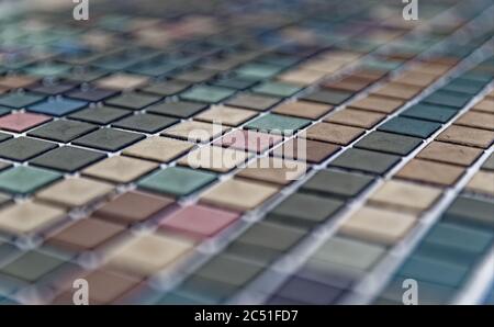 Closeup of a surface of colorful faded square tiles Stock Photo