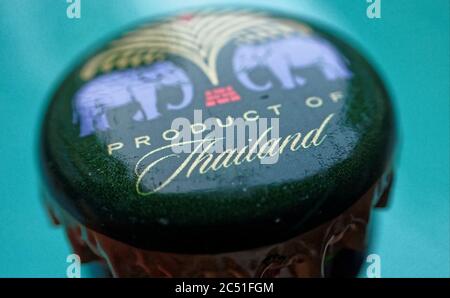 A close-up view of a dark green and gold Chang beer bottle cap with 'Product of Thailand' emblazoned on it Stock Photo