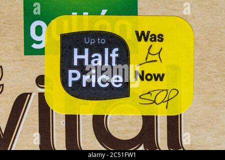 Up to half price yellow sticker label on food product - on box of Gullon Vital Grain breakfast cereal biscuits - price reduction, price mark down Stock Photo