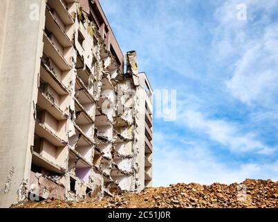 Demolished high rise building against the blue sky. Stock Photo