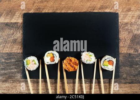 Sushi roll set with chopsticks. Place for your text or logo. Stock Photo