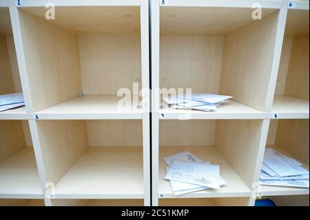 At the post office, sorting room: piles of letters placed in sorting cells Stock Photo