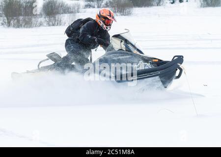 sports helmet rides a snowmobile Stock 