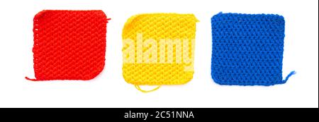 Three knitted patch squares: red, yellow, blue isolated on white background Stock Photo