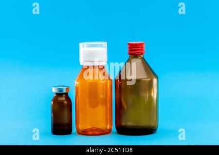 jar with medical disinfectants and a glass bottle for health treatment, pharmacy objects on a blue background with a copy space. Stock Photo