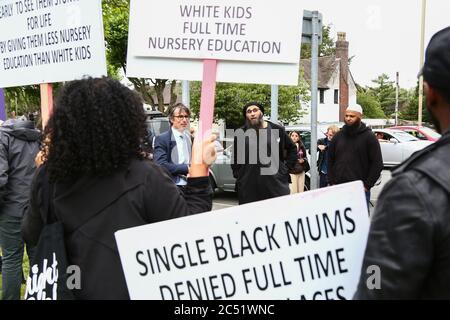 Dudley, West Midlands, UK. 30th June, 2020. As the Prime Minister Boris Johnson gave a speech in Dudley, a handful of protesters outside the college he was speaking in held up placards demanding full time nursery places for black children. Credit: Peter Lopeman/Alamy Live News Stock Photo