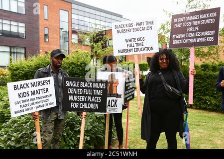 Dudley, West Midlands, UK. 30th June, 2020. As the Prime Minister Boris Johnson gave a speech in Dudley, a handful of protesters outside the college he was speaking in held up placards demanding full time nursery places for black children. Credit: Peter Lopeman/Alamy Live News Stock Photo