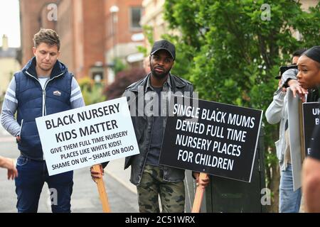 Dudley, West Midlands, UK. 30th June, 2020. As the Prime Minister Boris Johnson gave a speech in Dudley, a handful of protesters outside the college he was speaking in held up placards demanding full time nursery places for black children. Credit: Peter Lopeman/Alamy Live News Stock Photo