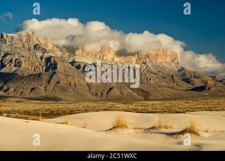 Salt Basin Dunes in front of western escarpment of snowcapped Guadalupe Mountains, sunset, Chihuahuan Desert, Guadalupe Mountains National Park, Texas Stock Photo