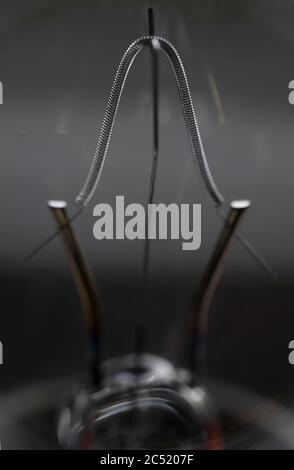 Close-up of a tungsten filament in a incandescent light bulb with narrow depth of field Stock Photo