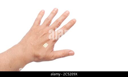 human hand holding a brush with an implanted microchip in the body for tracking and total control of the movement of the chipization plot, close-up is Stock Photo