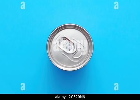 Aluminum drink or beverage can with pull ring on blue background. Top or overhead view. Stock Photo