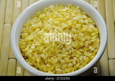 baked soybean in white cup on bamboo plate background Stock Photo