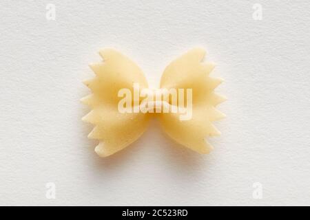 Farfalle or bow tie pasta on white background. Close up overhead view. Stock Photo