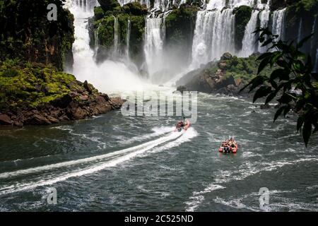 Speed boat rides under the water cascading over the Iguacu falls in Brazil Stock Photo
