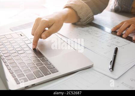 Close up of engineer or architect using laptop to planning project schedule., Engineering and construction concept. Stock Photo