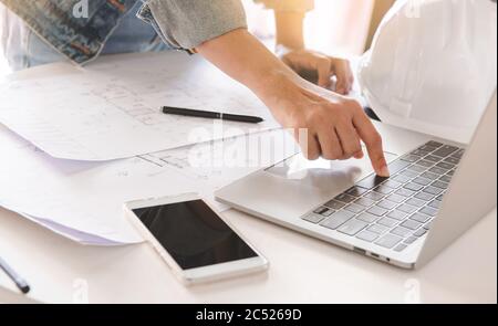 Top-View of engineers or architect using laptop to planning project schedule. Engineering and construction concept. Stock Photo