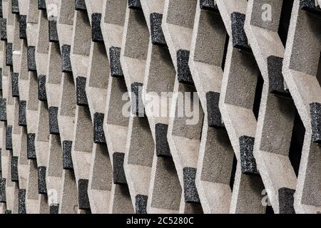Geometric symmetry design in modern architecture. Diamond grid pattern in cement and stone. Stock Photo